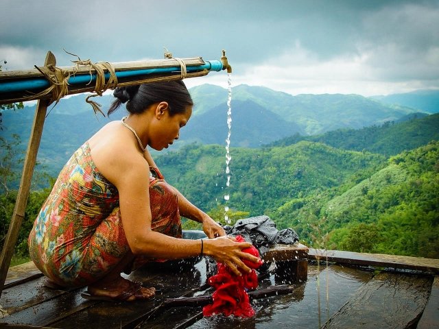 akha woman washing clothes